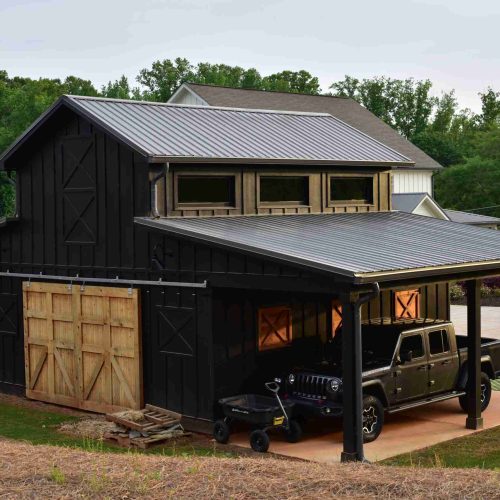 modern barndominium / fancy barn workshop. Black modern farmhouse exterior with cedar doors